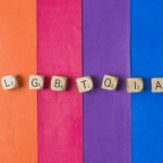 A vibrant artwork featuring the letters LGBTIA displayed on a lively background.