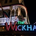 The wickham is lit up at night with rainbow flags, inviting visitors to come and explore the vibrant atmosphere of gay events near me.