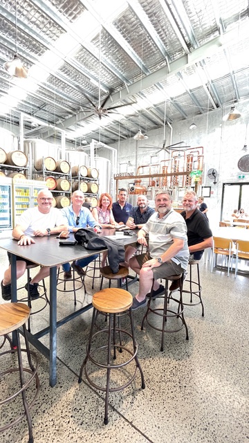 A group of people sitting in a brewery.